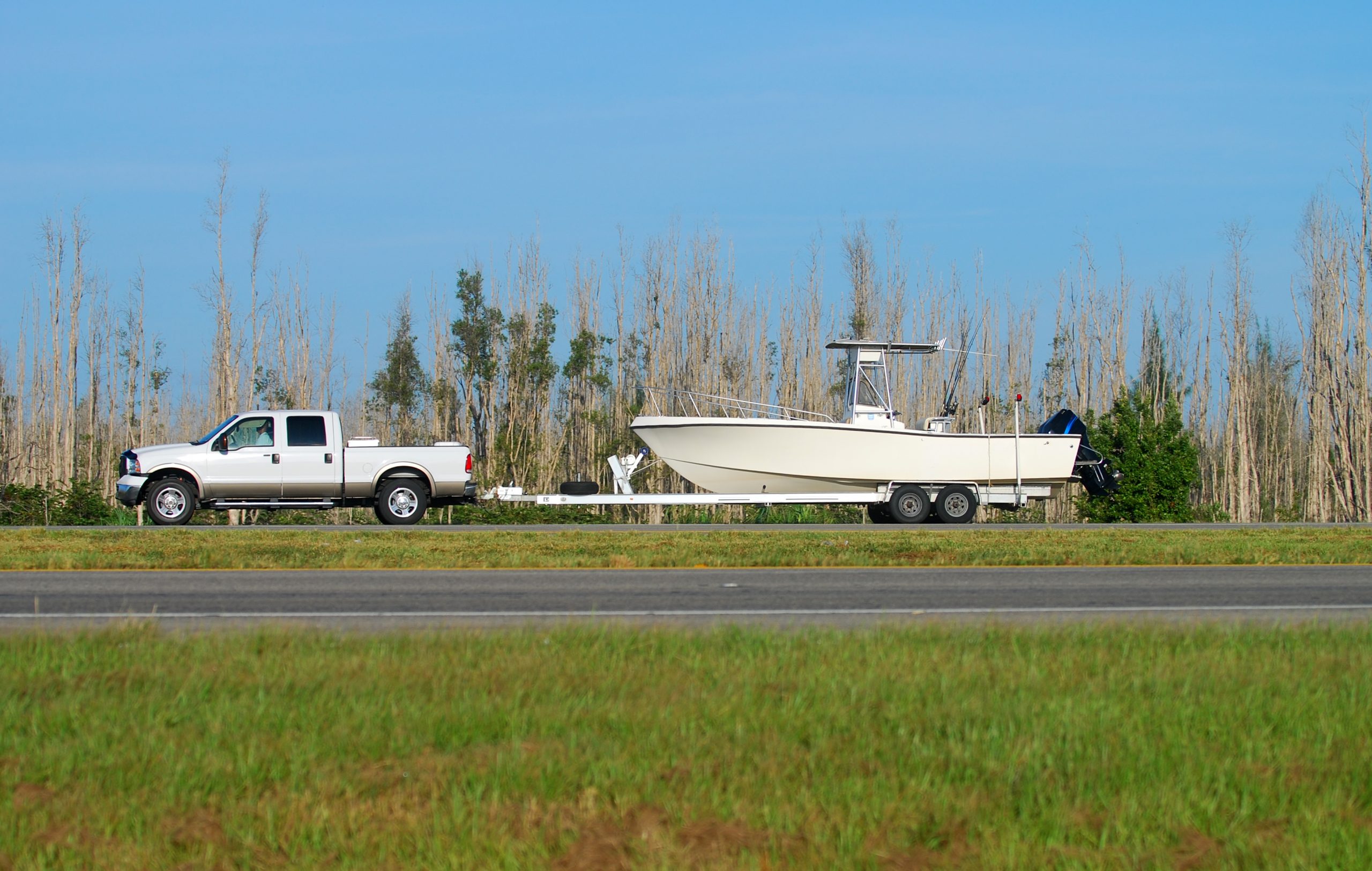 Truck pulling a boat on the road