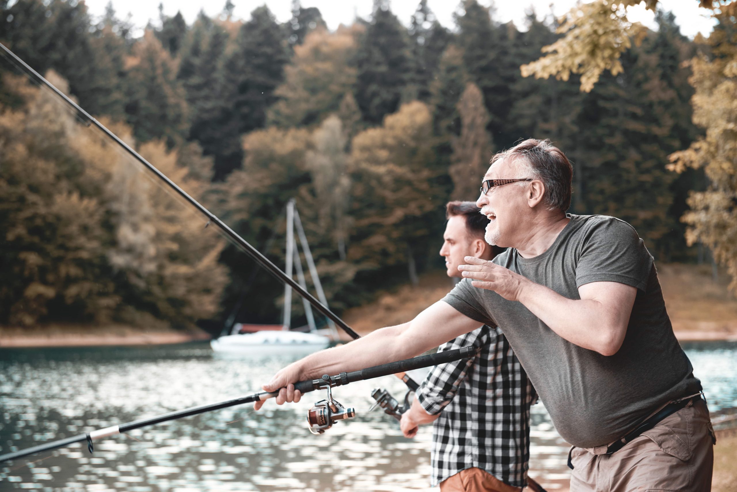 Man and son fishing on lake